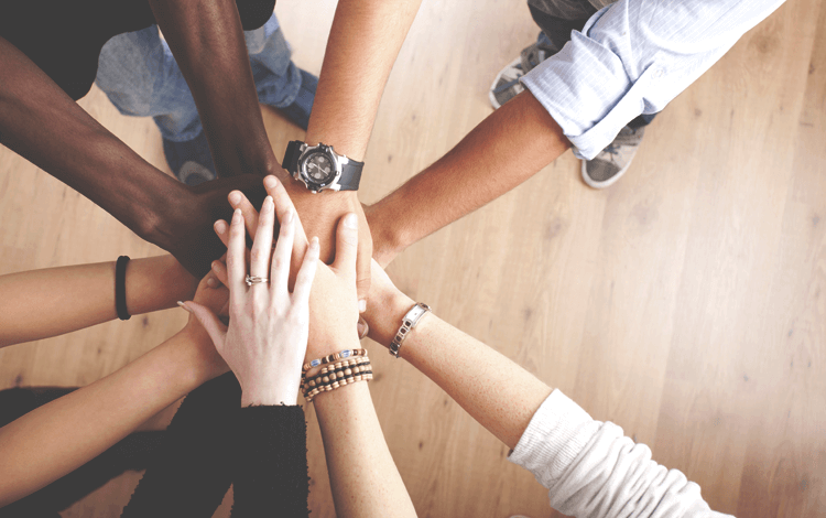 team members stacking hands
