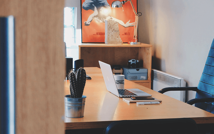 office desk with a laptop on it