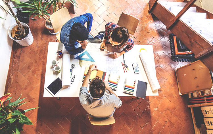 three persons working on a project