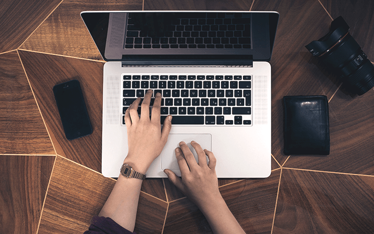 person typing on a laptop