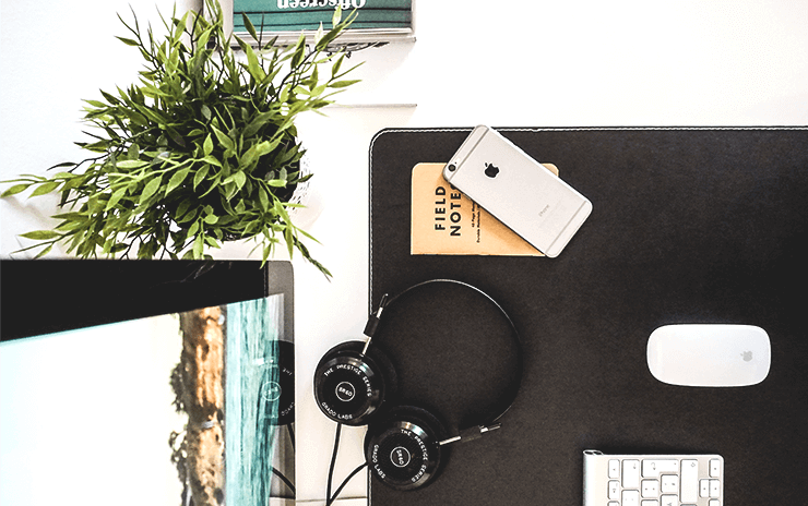 office desk with books and gadgets on top