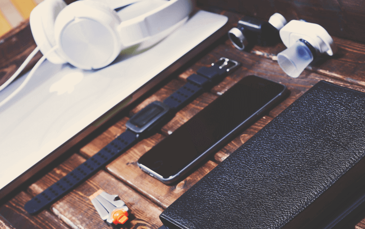watches, camera, phone and headphones on the table
