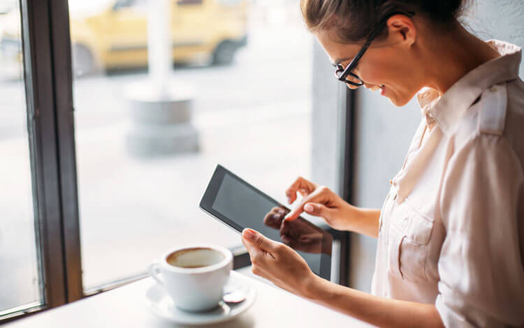woman typing on a tablet