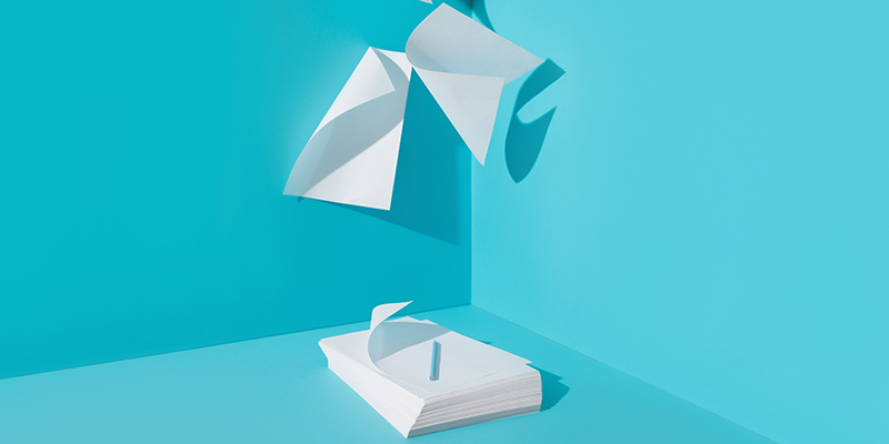 papers flying blue background